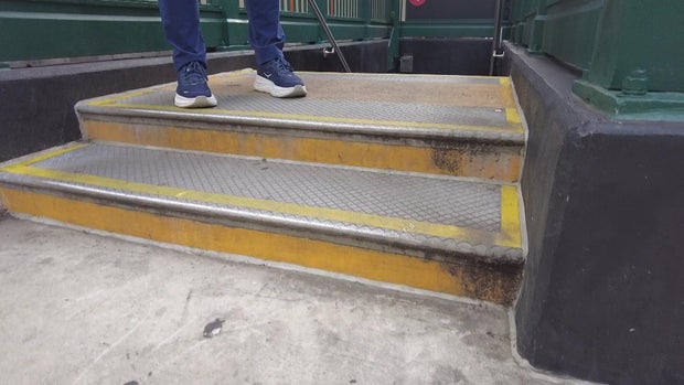 An elevated platform with one step at the entrance to an underground subway station. 