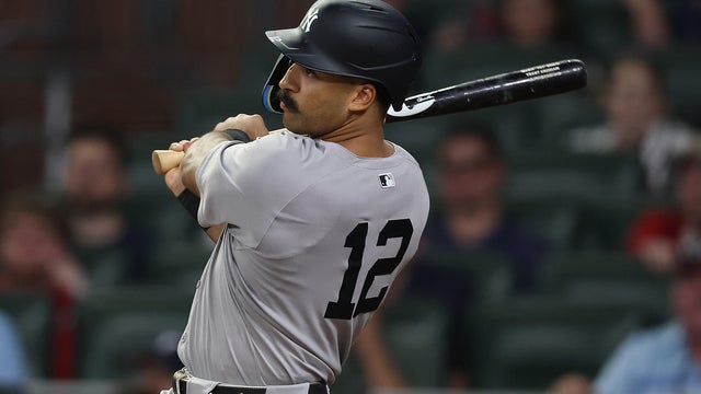 Trent Grisham #12 of the New York Yankees hits a grand slam in the ninth inning against the Atlanta Braves at Truist Park on July 19, 2025 in Atlanta, Georgia. 