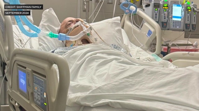 Peter Shiffman lying in a hospital bed in a medically induced coma 