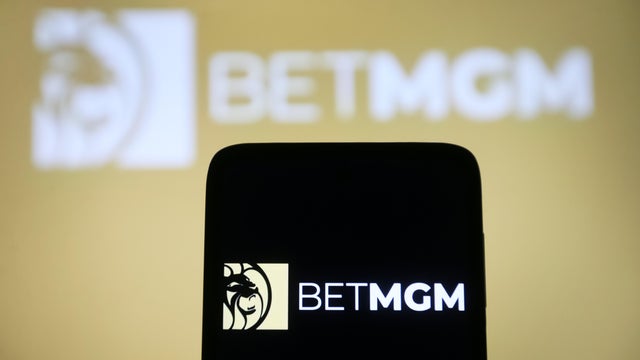 In this photo illustration, a BetMGM logo is seen on a 