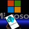 The SharePoint logo is displayed on a mobile phone with Microsoft visible on the screen, in this photo illustration in Brussels, Belgium, on July 23, 2025. 