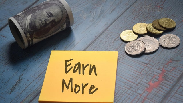 Earn More wording with money and coins. Financial concept 