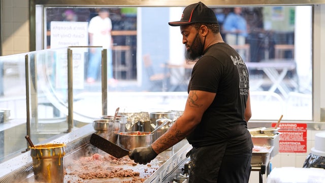 Malik Everett fries beef for a cheesesteak at Jim's South St. in Philadelphia 