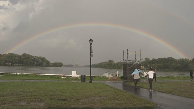 A rainbow is seen over the water at Cooper River Park 