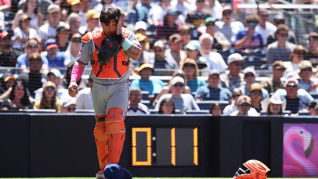 New York Mets catcher Francisco Alvarez reacts after taking a foul ball off his mask hit by San Diego Padres' Martin Maldonado in the fifth inning of a baseball game Wednesday, July 30, 2025, in San Diego. 