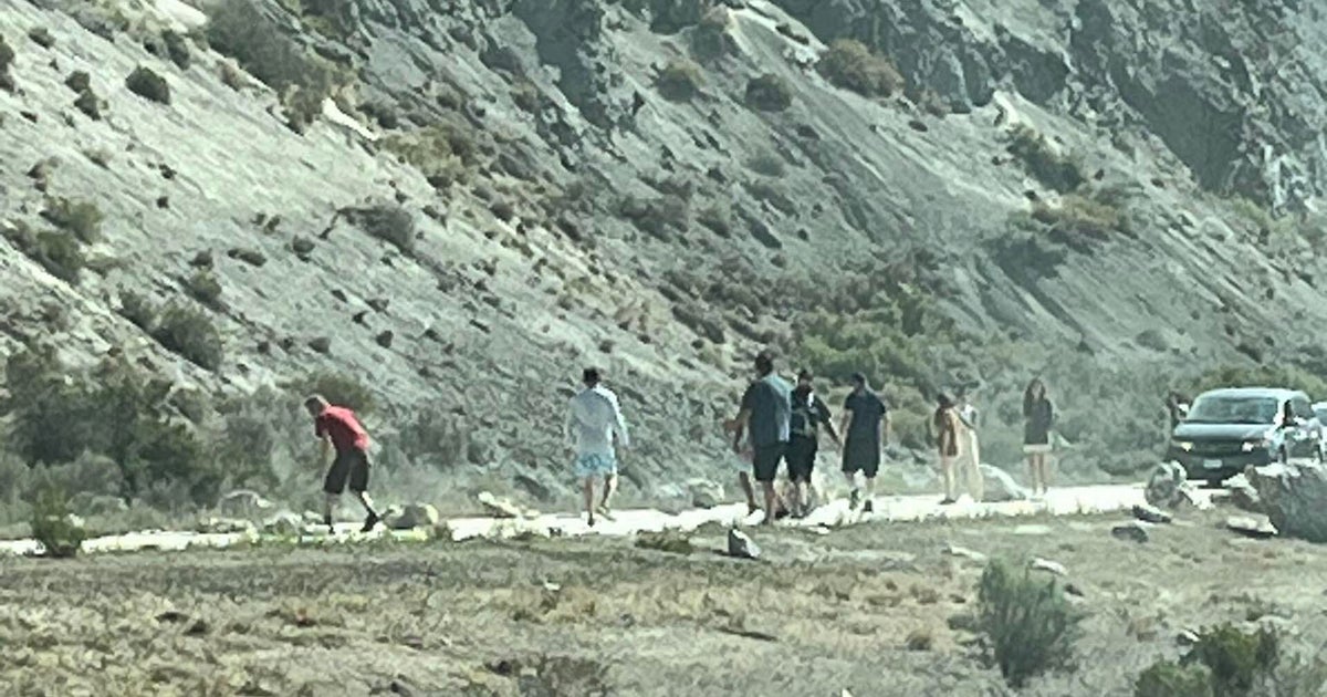 I-70 travelers get out of cars to help clear rock slide 