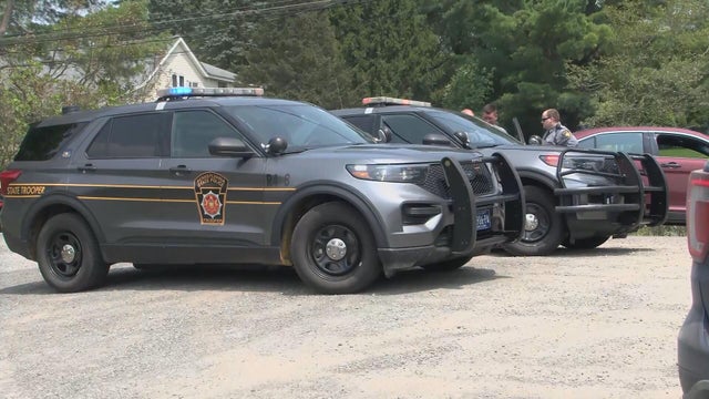 State police cars are at the scene of the shooting 