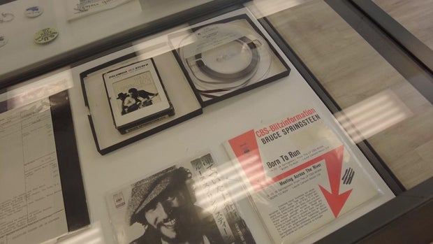 Bruce Springsteen "Born to Run" items on display in a glass case 