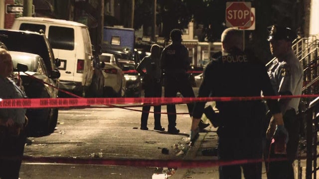 Police are looking around at a scene on South Etting Street in the Grays Ferry neighborhood of Philadelphia 
