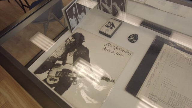 Bruce Springsteen "Born to Run" items on display in a glass case 