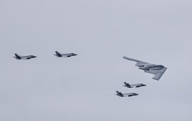F-35 jets and a B-2 bomber fly over Joint Base Elmendorf-Richardson ahead of Russian President Vladimir Putin and President Trump meeting in Alaska on Aug. 15, 2025. 