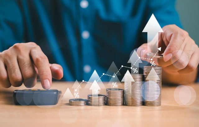 Money interest rate increase concept, percentage commission credit. Grow up stock risk management. Bank policy price raise. Businessman with coin, calculate high percentage of company profit dividend 