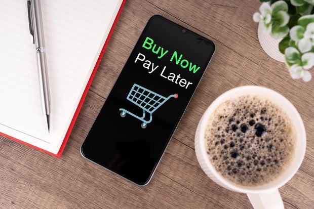 High Angle View of Smartphone with Text Buy Now Pay Later Shopping