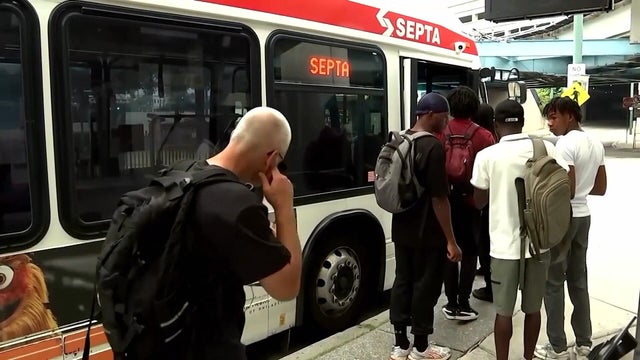 People line up to get on a SEPTA bus in Philadelphia 