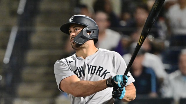 Giancarlo Stanton #27 of the New York Yankees hits a two-run home run in the 10th inning against the Tampa Bay Rays at George M. Steinbrenner Field on August 20, 2025 in Tampa, Florida. 