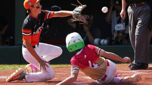 Las Vegas' Brooks Fechser (4) scores as Fairfield, Conn.'s Luca Pellegrini covers home on a wild pitch during the first inning of the United States Championship baseball game at the Little League World Series tournament in South Williamsport, Pa., Saturday, Aug. 23, 2025. 