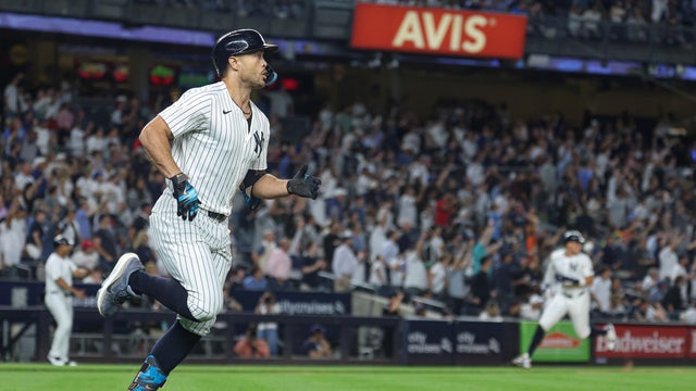 Giancarlo Stanton #27 of the New York Yankees hits a three run double during the third inning against the Washington Nationals at Yankee Stadium on August 26, 2025 in New York City. 