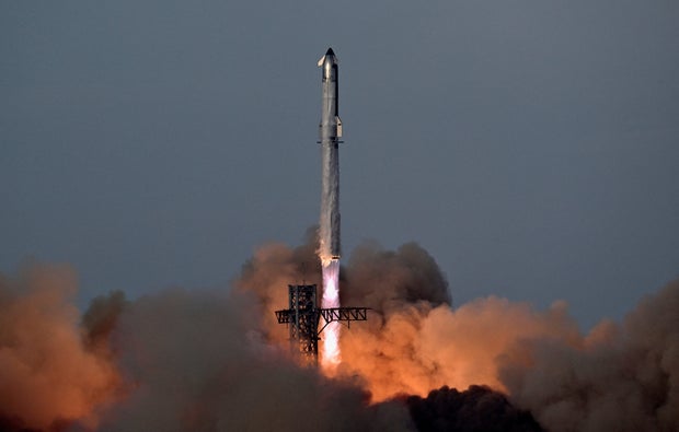 A SpaceX Super Heavy booster carrying the Starship spacecraft lifts off on its 10th test flight 