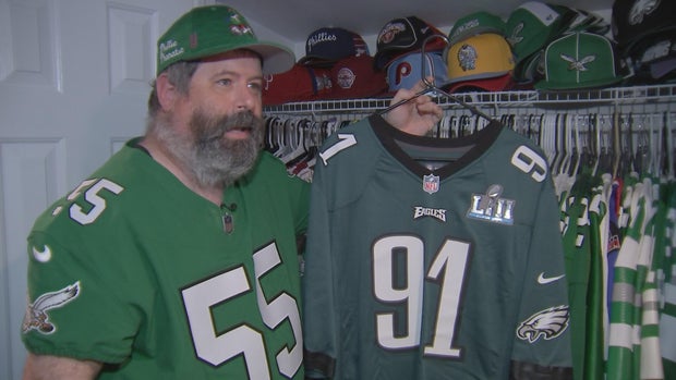 Neil Beck holds up a Fletcher Cox jersey