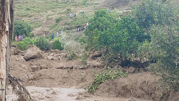 People gather at an area following a landslide that destroyed the Tersin village, in the Marra Mountains area of Sudan 