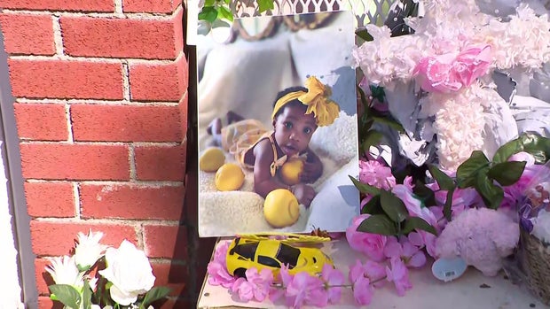A photo of River Wilson at a memorial outside a Bronx day care 