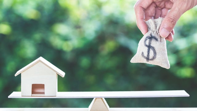 Balance home and money, home loan, reverse mortgage concept. 