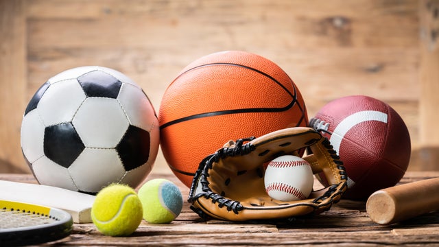 Variety Of Sport Accessories On Wooden Surface 