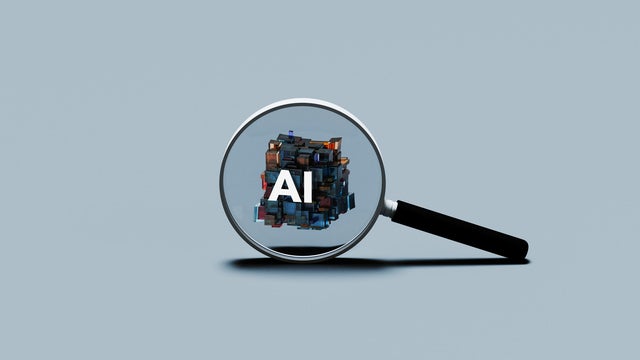 Magnifying Glass Focusing on AI Symbol 