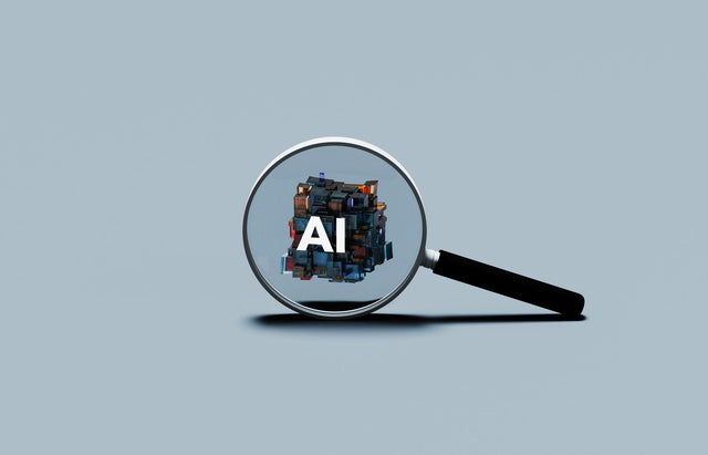 Magnifying Glass Focusing on AI Symbol 
