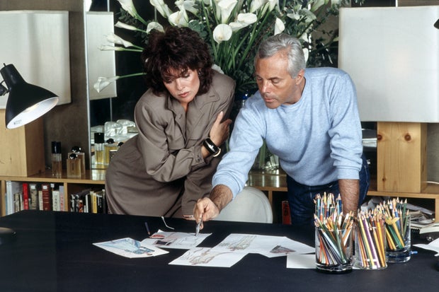 Giorgio Armani and Linda Gray looking at some sketches 