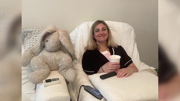 Dani Alderman lays in a hospital bed