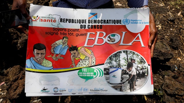 FILE PHOTO: Congolese volunteer Ferdinand Tangenyi displays a flip book he uses to inform people about the Ebola virus, in Goma 