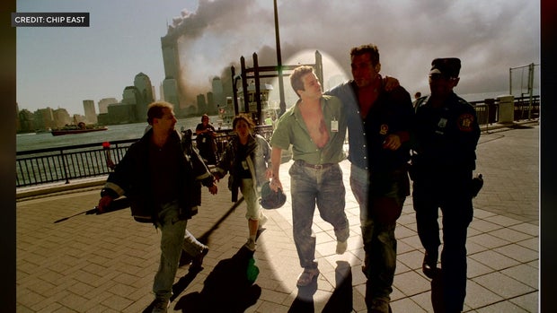 Mark Desire and several others walk away from the site of the 9/11 terror attacks 