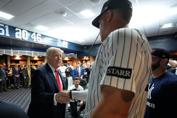 President Donald Trump shakes hands with New York Yankees Aaron Judge in the New York Yankees locker room before a baseball game against the Detroit Tigers, Thursday, Sept. 11, 2025, in New York. 