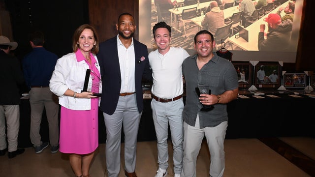 People pose for photos during the KB Foundation's BBQ Experience event 