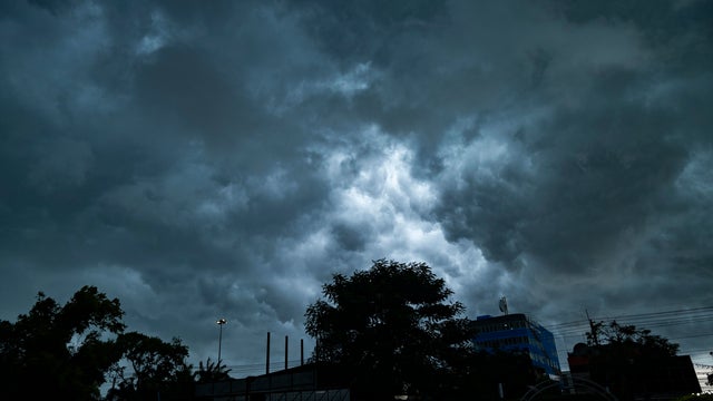 Dramatic cloud Before  Heavy rain falling against the Lighting extreme weather and climate and global warming. 