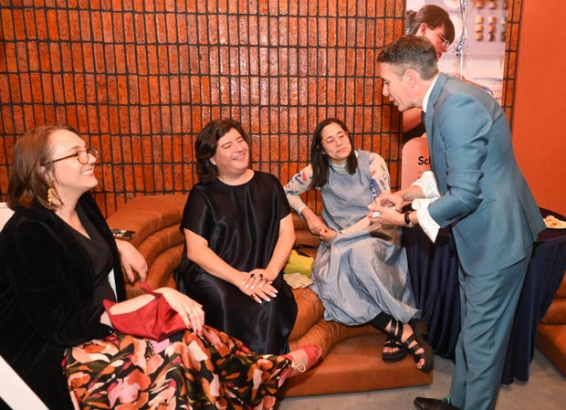 People pose for photos at Mud Ball 2025