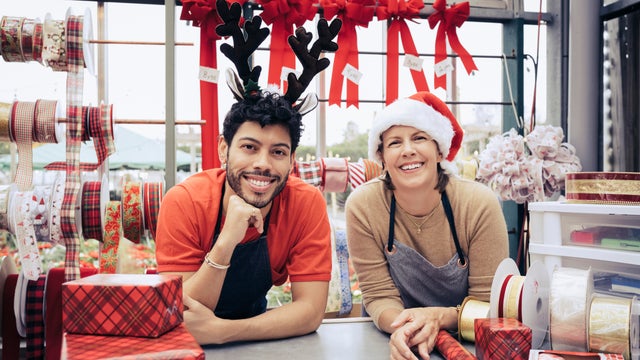 Portrait of smiling co-workers in Christmas shop 