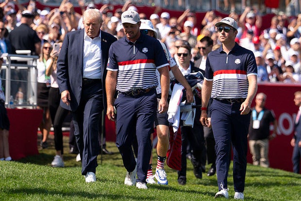 President Trump walks with Bryson DeChambeau and Ben Griffin to the first tee during the Ryder Cup at Bethpage State Park in Farmingdale, New York, on Sept. 26, 2025.