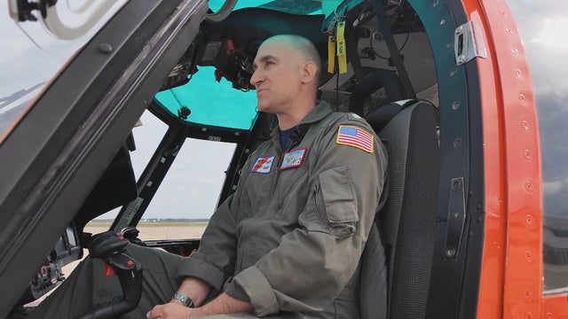 Commander Popiel looks ahead in his helicopter 