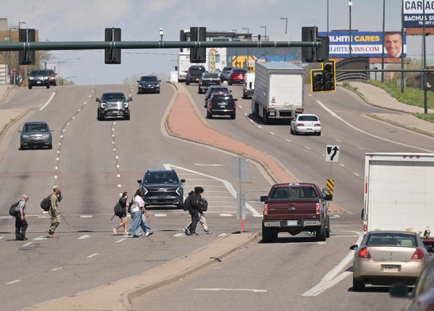 Pedestrians cross eight lanes of traffic 