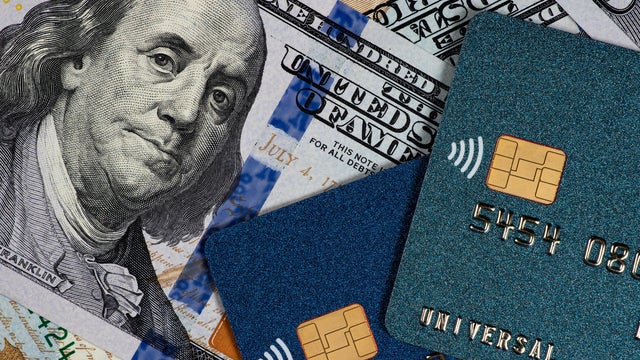 Credit cards and dollars in cash close up 