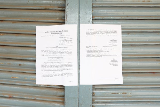 A notice by local drug administration is displayed on the sealed medical clinic of a doctor accused of prescribing cough syrup linked to the deaths of multiple children, in Parasia