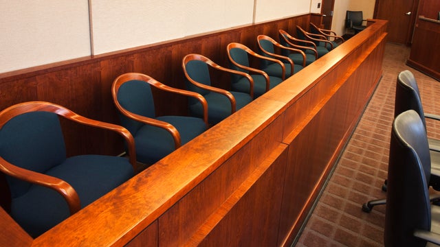 Empty seats in the jurors row in the court room 