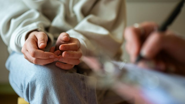 Close-up of therapy session with anxious teenage girl 