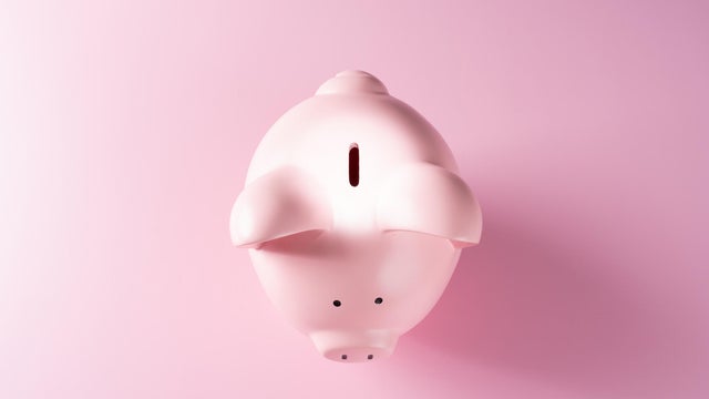 Spotlight Focused on the Coin Slot of a Piggy Bank 