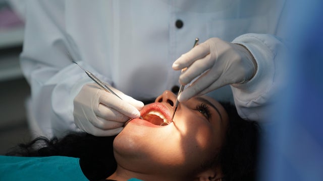 Dentist checking patient's teeth . 