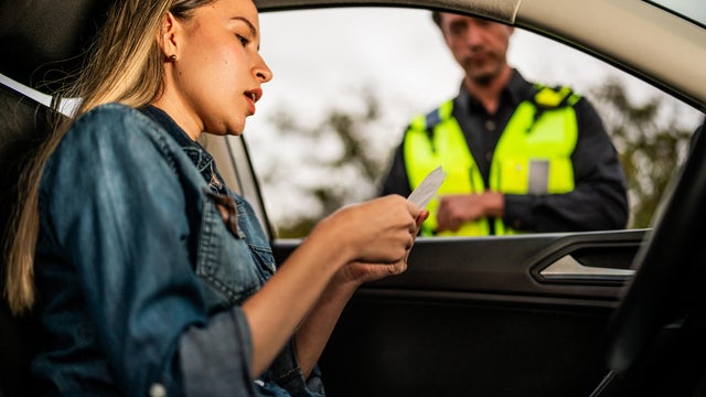 Teenage girl learning to drive from mother during weekend 
