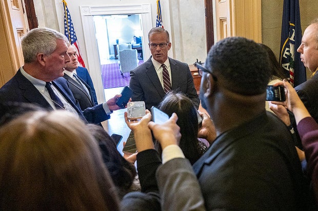 Reporters ask questions as Senate Majority Leader John Thune of South Dakota enters his office at the U.S. Capitol in Washington, D.C., on Oct. 29, 2025.
