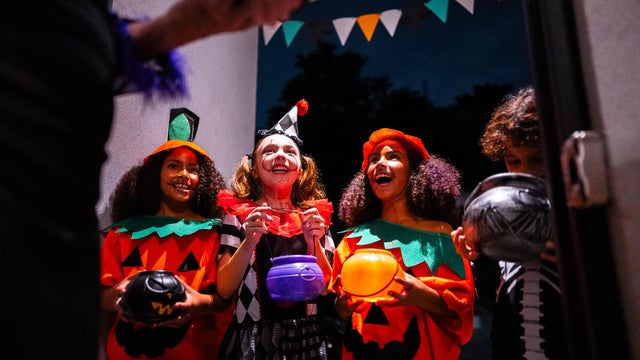 Kids asking trick or treat on Halloween on the city